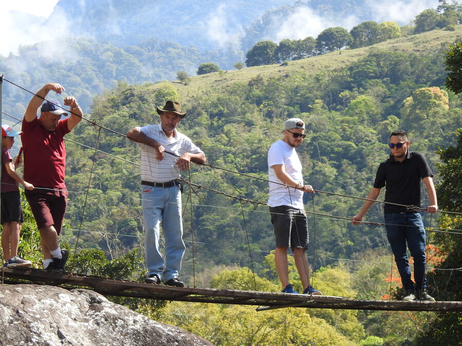 Locals watching from the riverside bridge